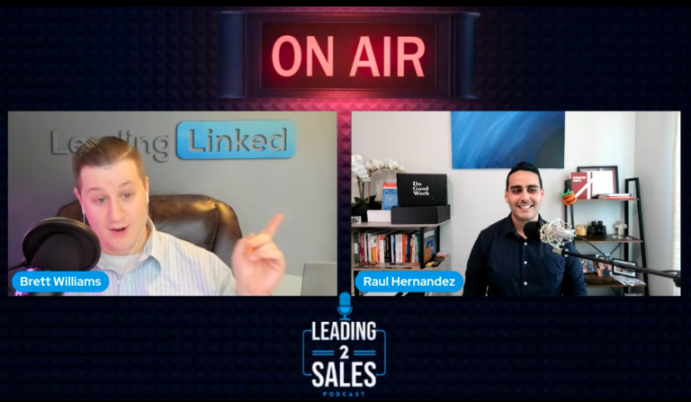Two persons in a podcast setup with microphones, a bookshelf, and an "On Air" sign prominently displayed above them.